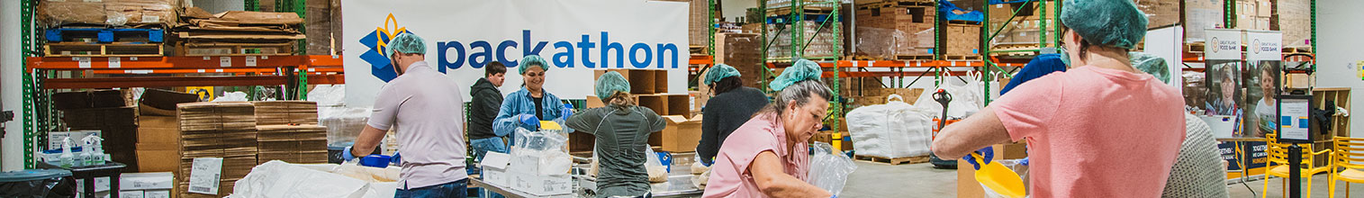 Employees packing food for a food bank
